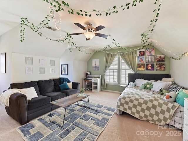 bedroom featuring lofted ceiling, a ceiling fan, visible vents, and carpet flooring