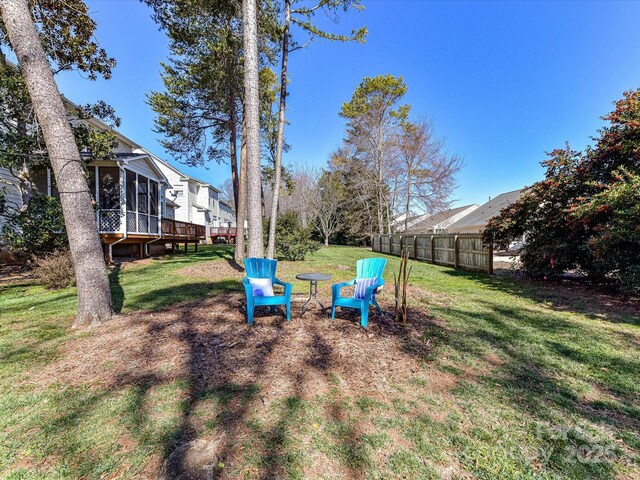 view of yard with a sunroom and fence