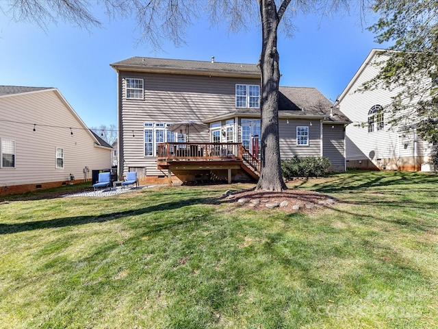 back of property with a patio, a lawn, and a wooden deck