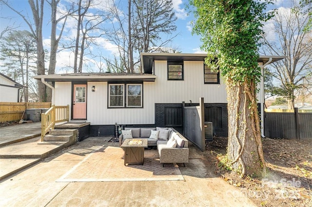 back of house with an outdoor hangout area and fence