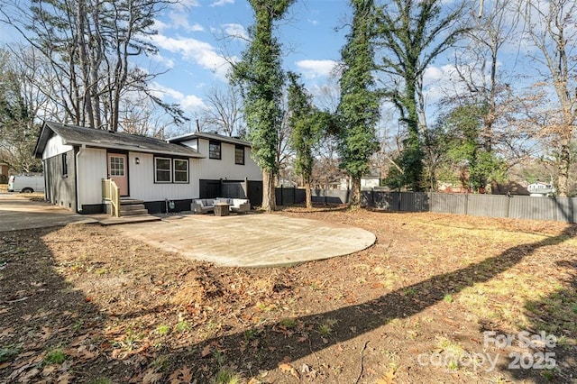 view of yard with a patio area, a fenced backyard, and an outdoor living space