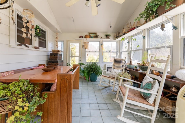 sunroom featuring vaulted ceiling and ceiling fan