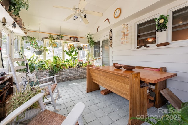 sunroom featuring ceiling fan and vaulted ceiling