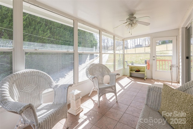 sunroom / solarium with a ceiling fan