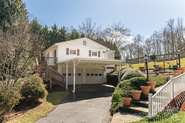 view of front of house with stairs, driveway, and an attached garage