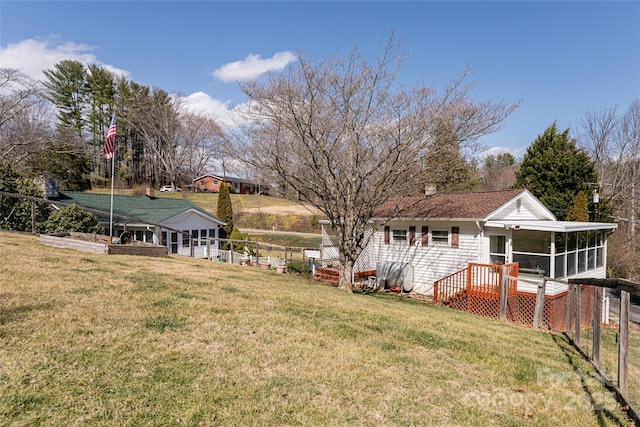 view of yard featuring a sunroom and fence