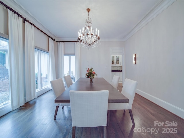 dining room with baseboards, dark wood-style flooring, a chandelier, and crown molding