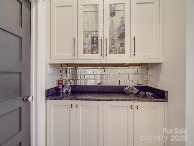 bar featuring a bar and backsplash