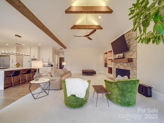 living room featuring high vaulted ceiling, a fireplace, wood finished floors, baseboards, and beamed ceiling