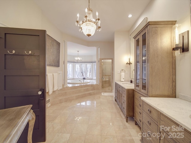 full bath with a garden tub, a notable chandelier, vanity, a shower stall, and tile patterned floors