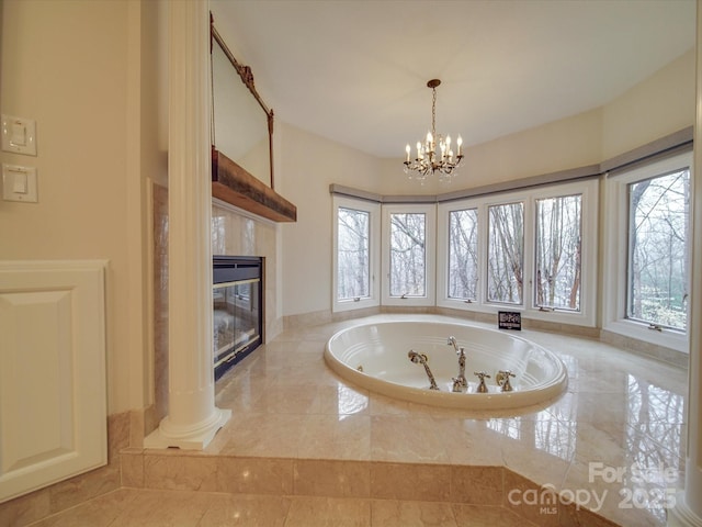 bathroom featuring a fireplace and an inviting chandelier