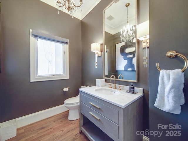 bathroom featuring a chandelier, ornamental molding, vanity, and visible vents