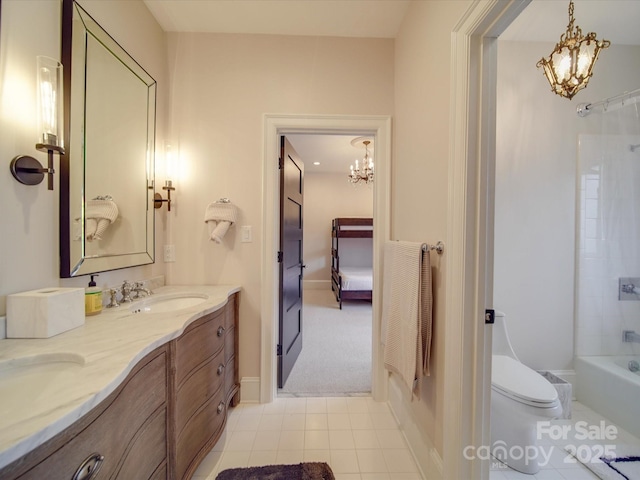 bathroom with a notable chandelier, a sink, toilet, and double vanity