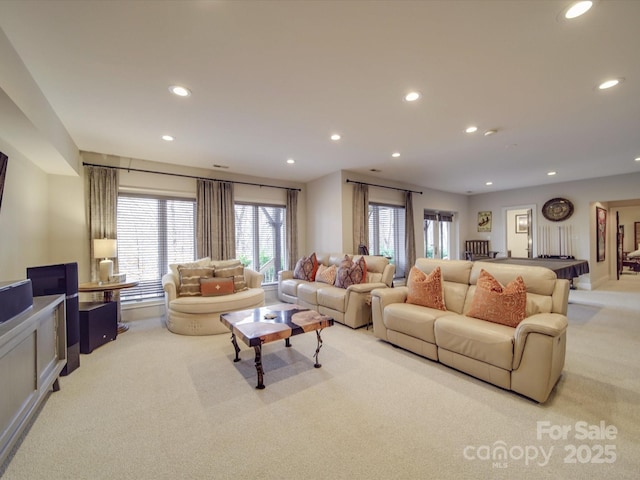 living room featuring light carpet and recessed lighting