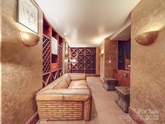 wine room featuring brick floor and recessed lighting