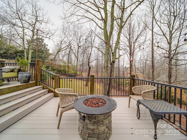 wooden deck with an outdoor fire pit