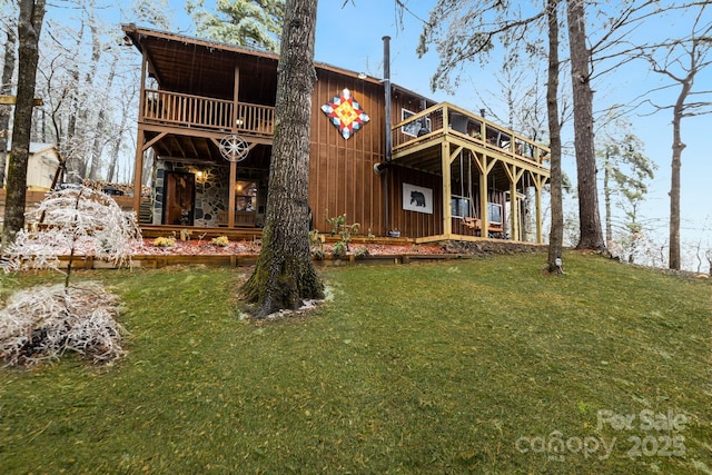 view of front facade with a deck and a front yard