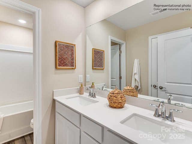 bathroom featuring toilet and vanity