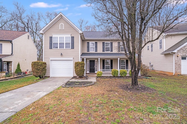 traditional home featuring a porch, concrete driveway, an attached garage, and a front lawn