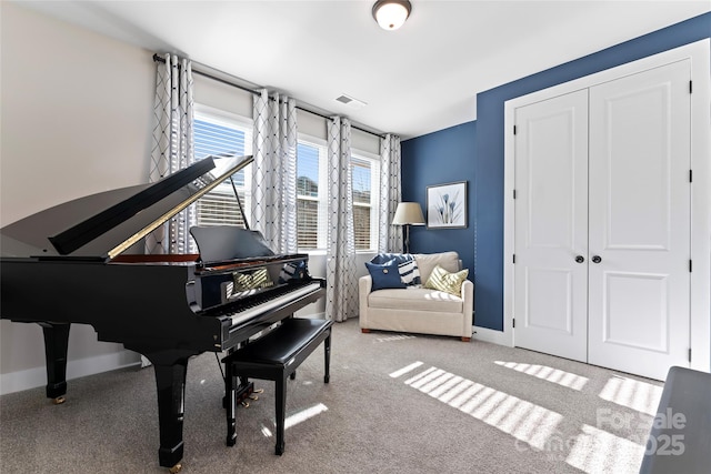 sitting room featuring carpet flooring, visible vents, and baseboards