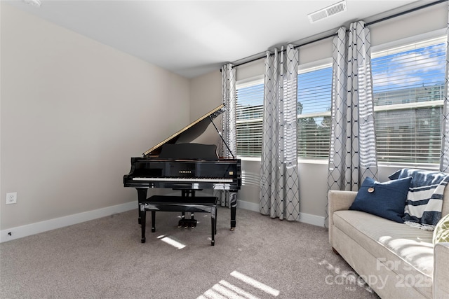 sitting room featuring carpet floors, visible vents, and baseboards