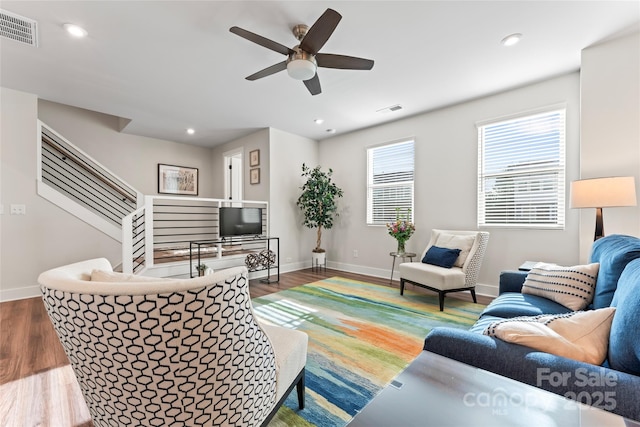 living room featuring baseboards, dark wood-type flooring, visible vents, and recessed lighting