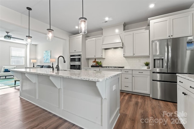 kitchen featuring white cabinetry, a kitchen island with sink, and appliances with stainless steel finishes