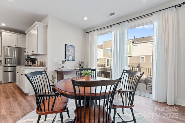 dining room with recessed lighting, visible vents, and light wood-style flooring