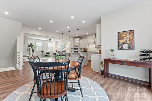 dining area featuring recessed lighting and light wood finished floors