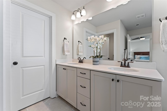 ensuite bathroom featuring double vanity, ensuite bath, visible vents, and a sink