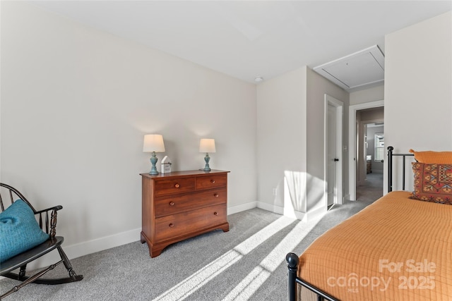 bedroom with attic access, light colored carpet, and baseboards