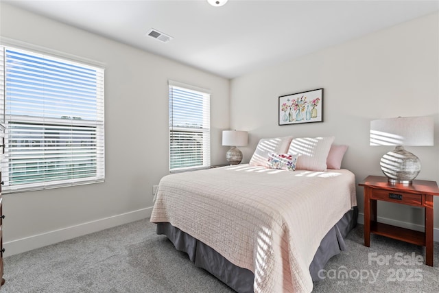 bedroom featuring light colored carpet, visible vents, and baseboards