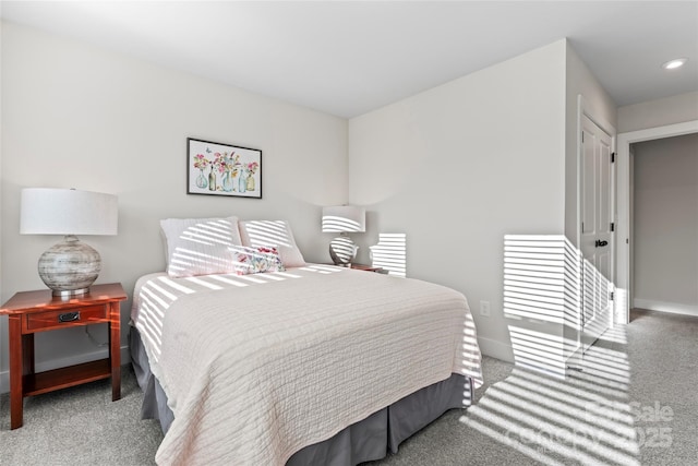 bedroom with recessed lighting, light colored carpet, and baseboards