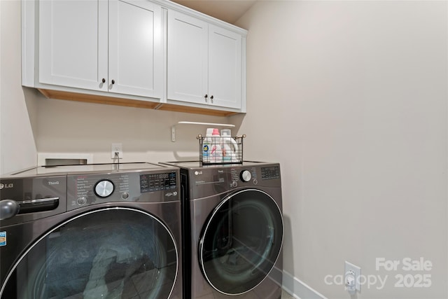 washroom featuring washer and dryer and cabinet space