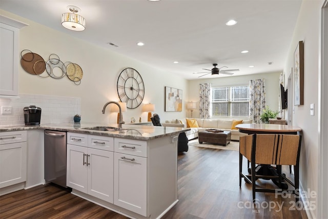 kitchen with white cabinetry and open floor plan