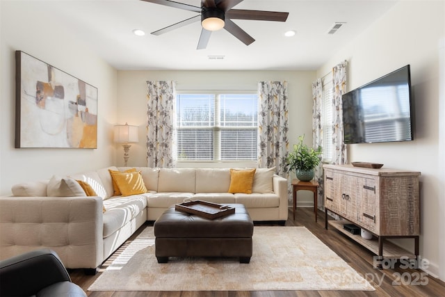 living room featuring dark wood-style floors, visible vents, and recessed lighting