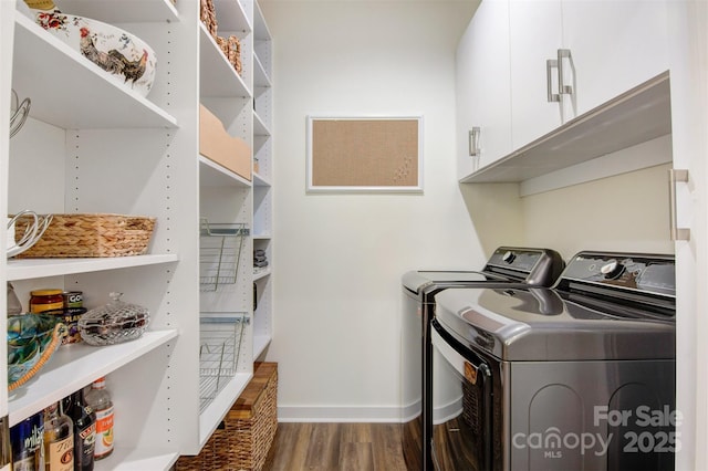 laundry room with cabinet space, washing machine and dryer, baseboards, and wood finished floors