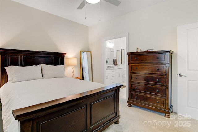 bedroom with connected bathroom, a ceiling fan, and light colored carpet