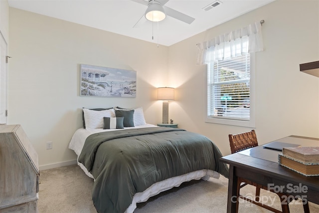 bedroom featuring baseboards, visible vents, and light colored carpet