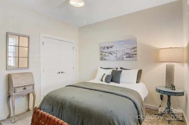 bedroom with a ceiling fan, a closet, light colored carpet, and baseboards