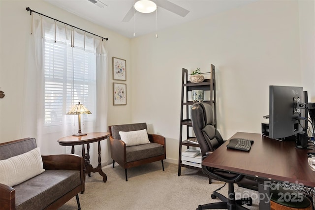 office space featuring a ceiling fan, light carpet, and visible vents