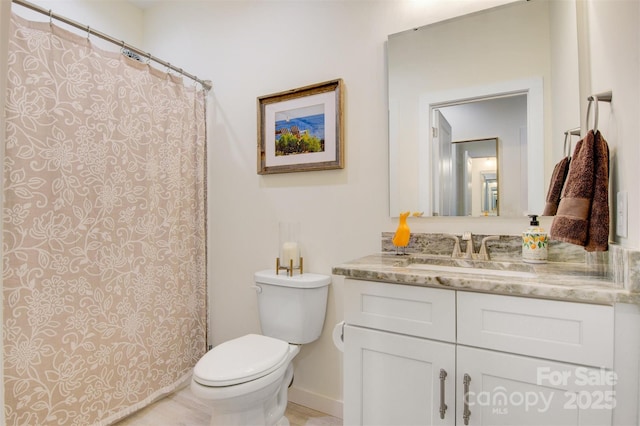 full bath featuring toilet and vanity