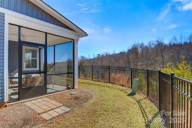 view of yard with a sunroom and a fenced backyard