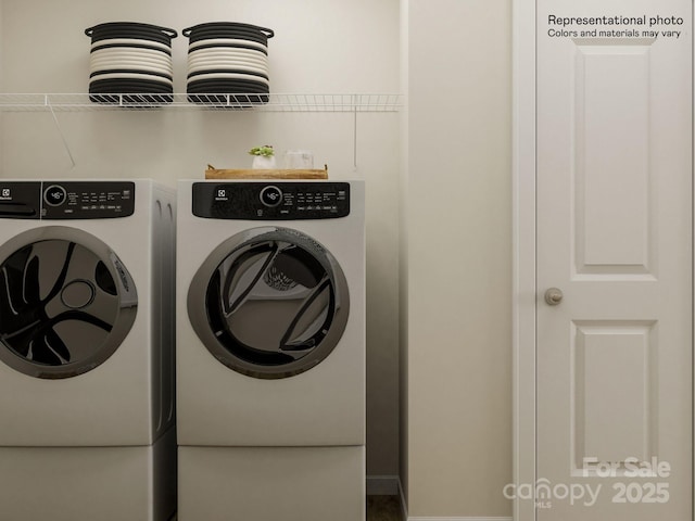 clothes washing area with washer and dryer