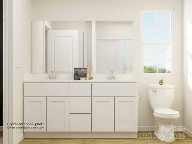 bathroom featuring wood-type flooring, vanity, and toilet