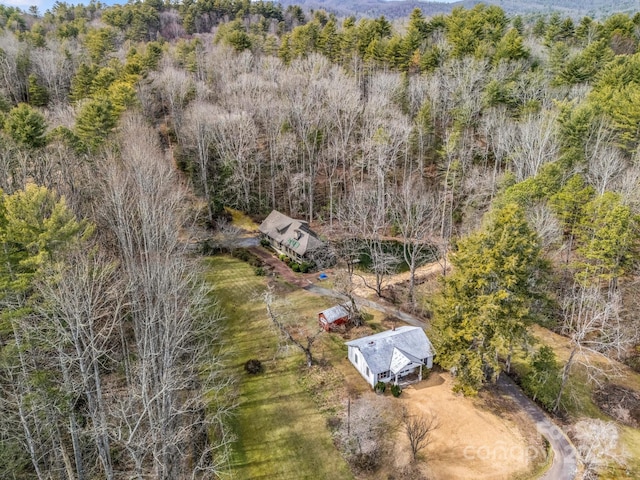 bird's eye view featuring a wooded view