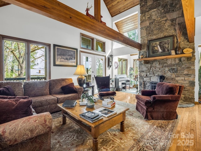 living room featuring high vaulted ceiling, wood finished floors, and french doors