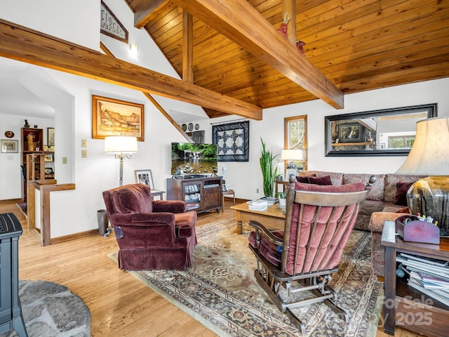 living area with high vaulted ceiling, wooden ceiling, baseboards, light wood-style floors, and beamed ceiling