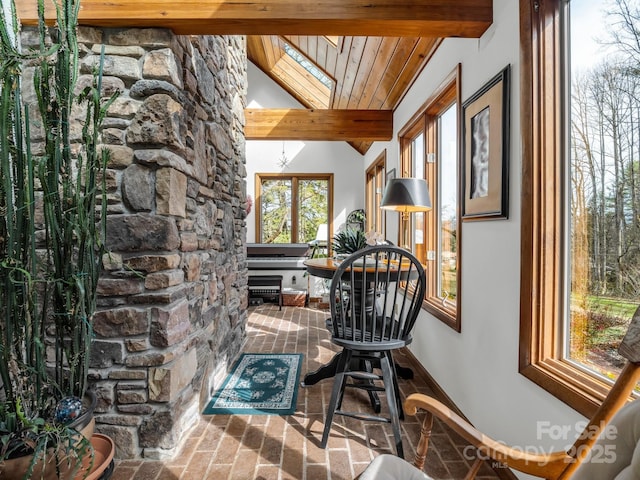 sunroom / solarium featuring lofted ceiling with beams