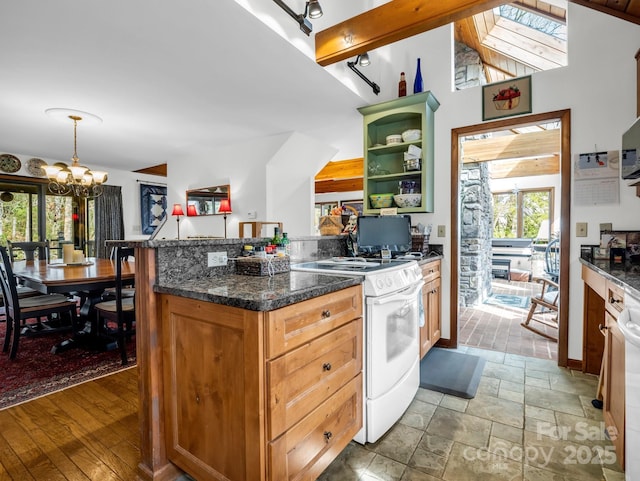 kitchen featuring pendant lighting, stone tile floors, open shelves, an inviting chandelier, and white range with gas stovetop